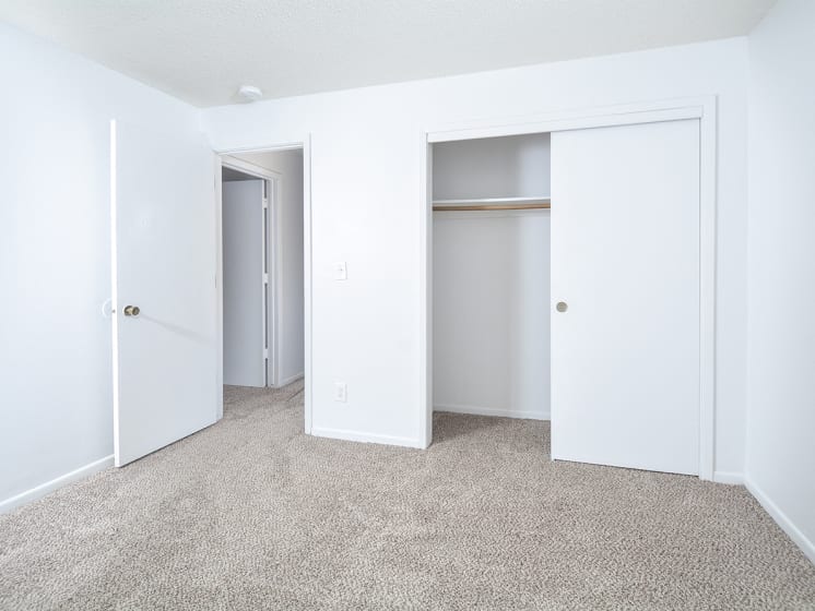 Carpeted Bedroom with Sliding Closet Doors