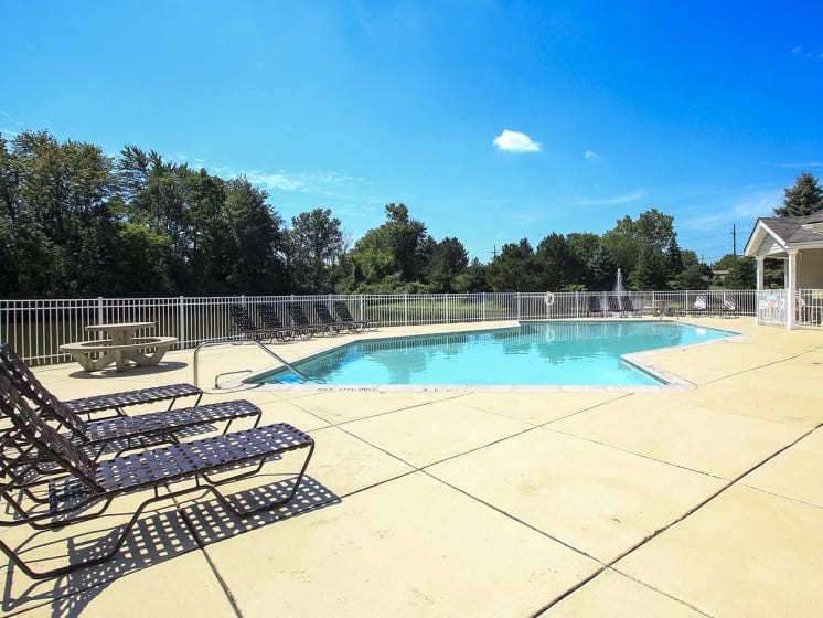 Large Sundeck Surrounding Outdoor Pool with Lounge Chairs