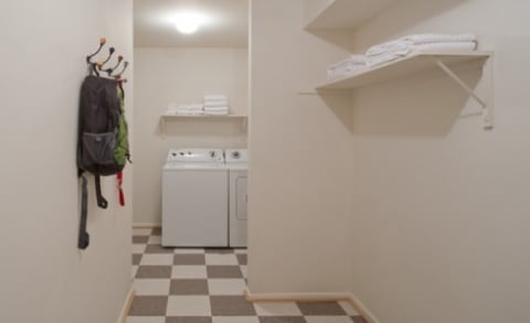 In-Home Laundry Room with a Full-Size Washer & Dryer and Built-in Shelves