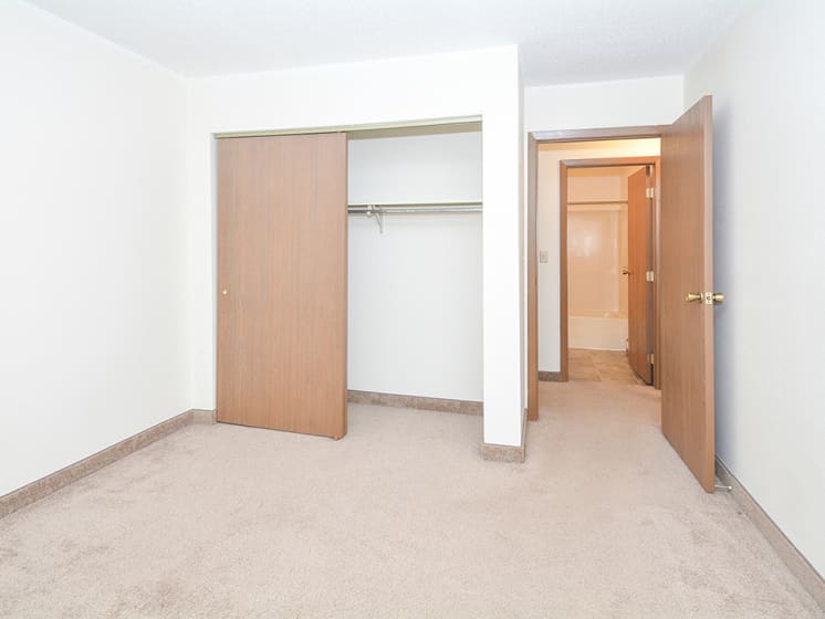 Bedroom with Sliding Closet Doors and Across from Bathroom