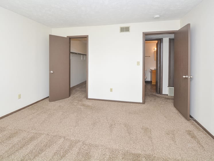 Carpeted Bedroom with Plush Carpet and Walk-In Closet