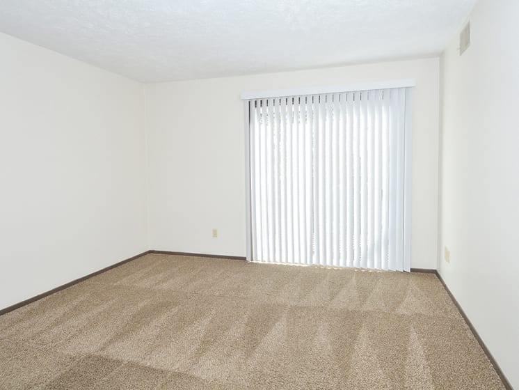 Carpeted Living Room with Glass Patio Door and Built-In Blinds