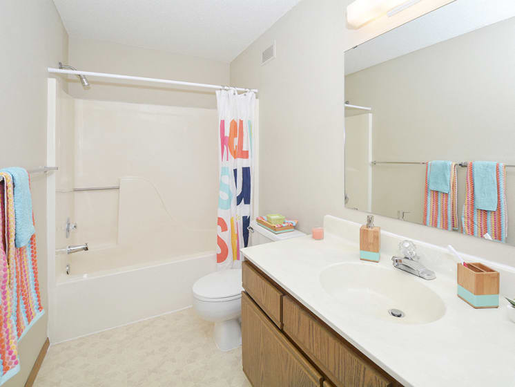 Full-Sized Bathroom with Tile Style Flooring and Large Vanity