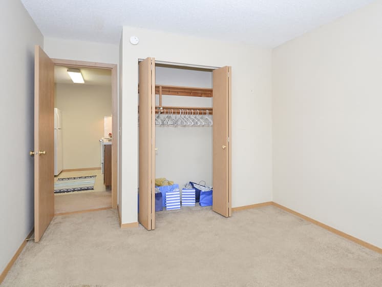 Bedroom with Sliding Wood Style Closet Doors