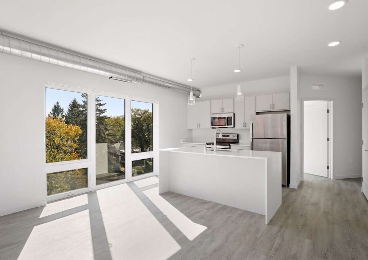 Bright modern LH44 kitchen with stainless steel appliances and white cabinetry