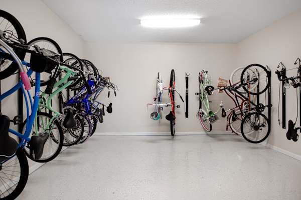 A bike rack with many bikes hanging on it.