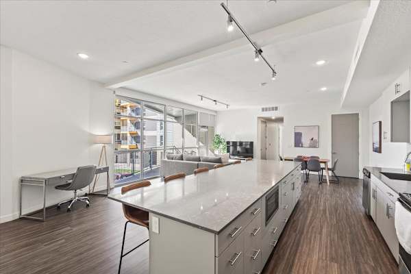 A modern kitchen with a long island and stainless steel appliances. at Paperbox Lofts Apartments, Utah