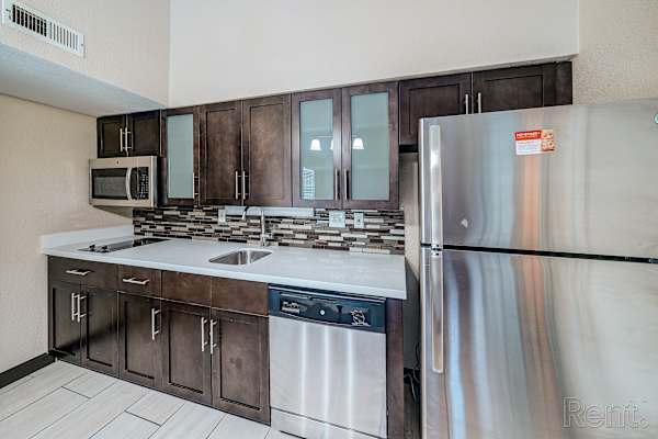 Kitchen with Brown Cabinets at Avia Lofts at Founders Road, Indiana