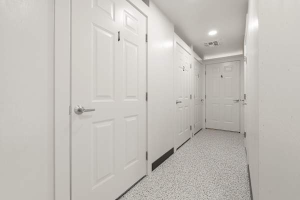A hallway with white doors and a black baseboard. at AVIA Lofts on Parkway, Washington