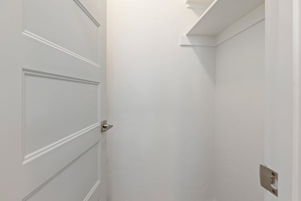 A white door with a silver handle is in a white room. at AVIA Lofts on Victors Way, Boise, ID