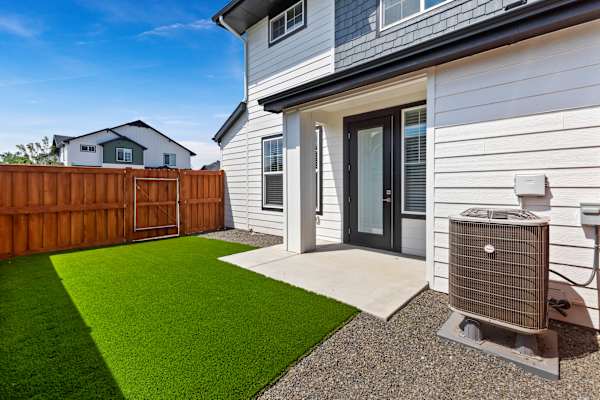 A house with a white siding and a black door is shown. at AVIA Lofts on Victors Way, Boise Idaho