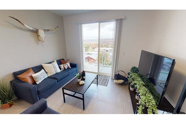 living room with couch, tv and window at 605 Place Student Housing & Co-Living, St George, UT