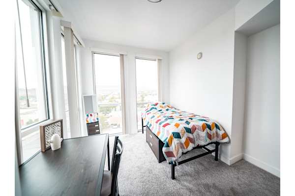 Cozy bed setup with bright windows at 605 Place Student Housing & Co-Living, St George Utah