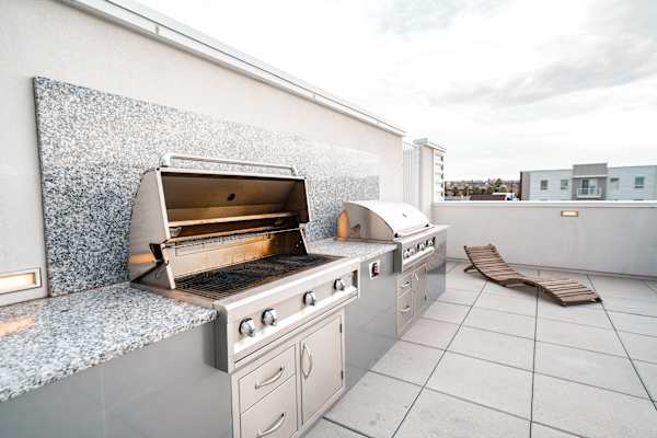 A white outdoor kitchen with a grill and oven. at 605 Place Student Housing & Co-Living, Utah