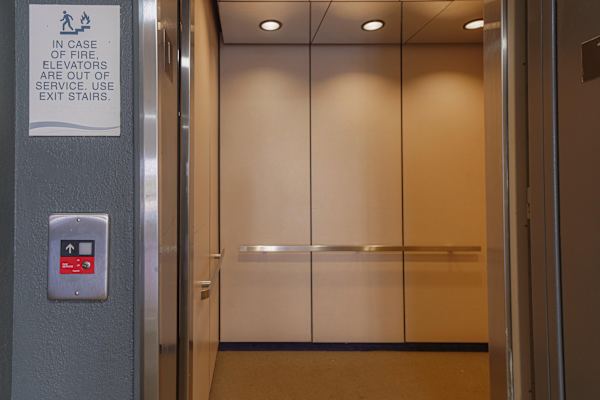 An elevator with a sign that says in case of fire, use exit stairs. at The Revival, Salt Lake City
