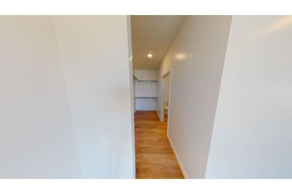 A long hallway with a door at the end.
