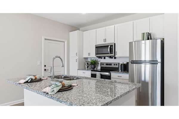 A kitchen with granite countertops and stainless steel appliances.