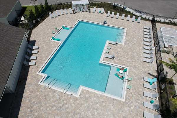 A large outdoor swimming pool surrounded by lounge chairs.
