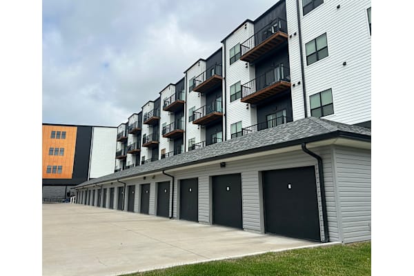 A long building with a lot of garage doors.