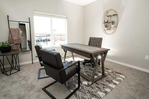 A room with a table and chairs in it.