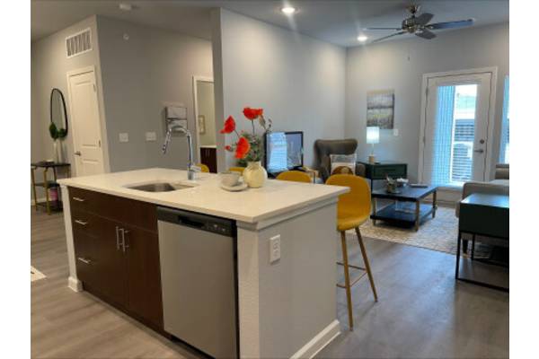 a kitchen with an island in the middle of a living room