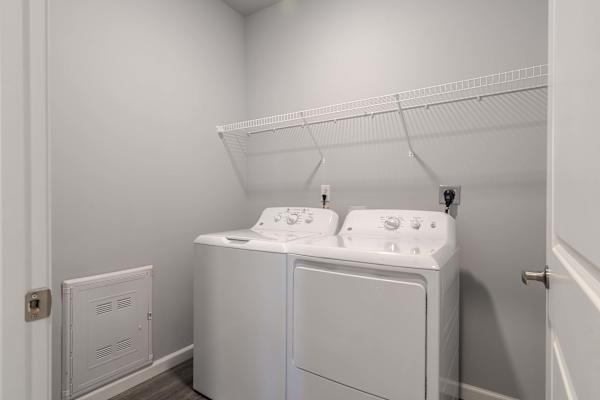 A white laundry room with a washer and dryer.