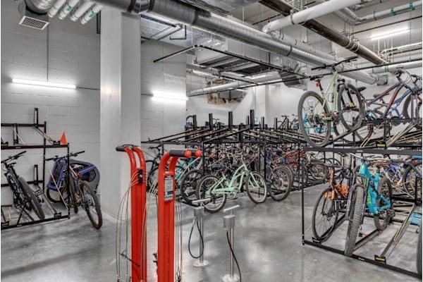 A bike rack with many bikes parked.
