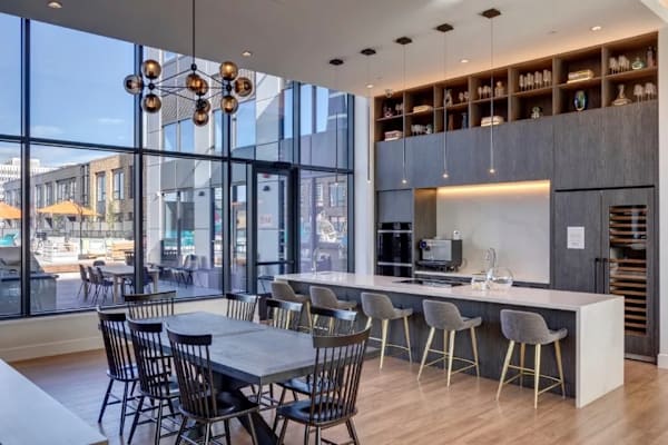 A modern dining area with a long table and chairs.