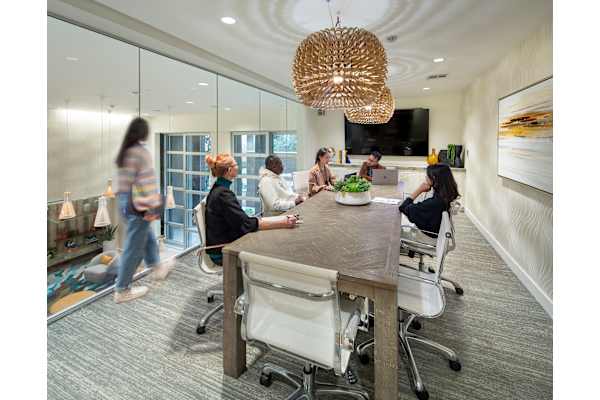 a group of people sitting around a table in an office