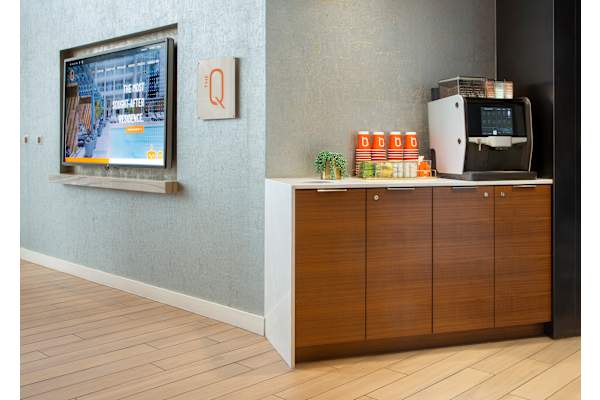 a room with a television and a coffee maker in it