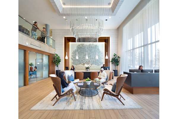 a rendering of a hotel lobby with a large chandelier and people in the background