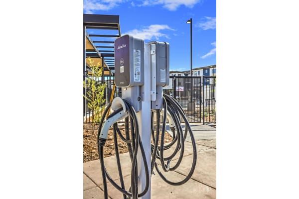 a charging station with a bunch of cables plugged into it