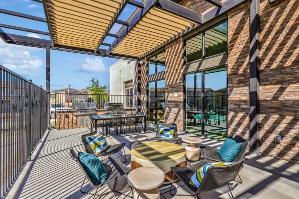 a patio with tables and chairs and a building in the background