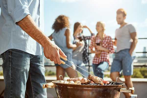 Friends enjoying sunday noon at rooftop BBQ