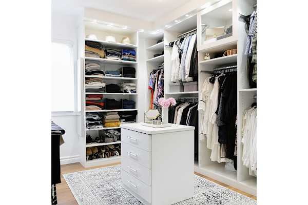 Spacious walk-in closet with with shelves and center isle