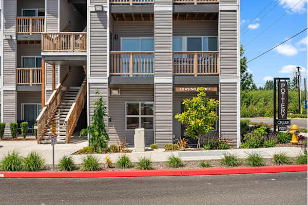 A multi-story apartment building with a leasing office on the ground floor.