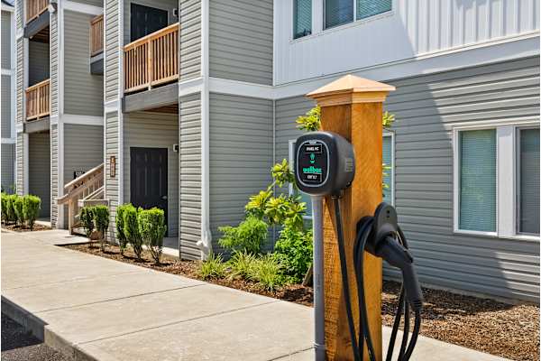 A charging station for electric vehicles is installed in front of a building at Pottery Creek Apartments, Port Orchard, 98366