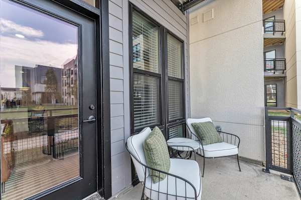 The Plaza at Pinnacle Hills balcony with two chairs and accent table