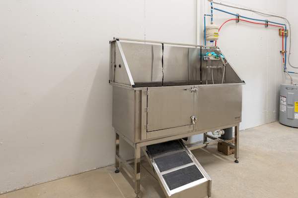 A large industrial machine with a grey exterior and a door on top.