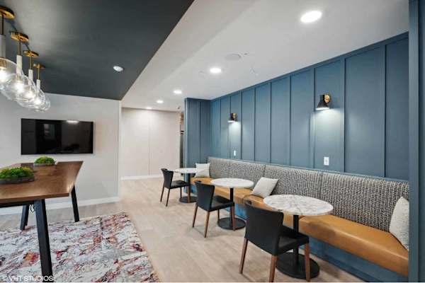 A modern dining area with a wooden table and chairs.