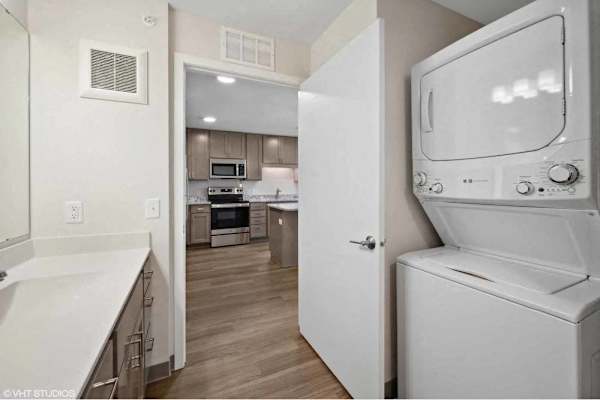 A white oven and microwave are in a kitchen with a white counter.