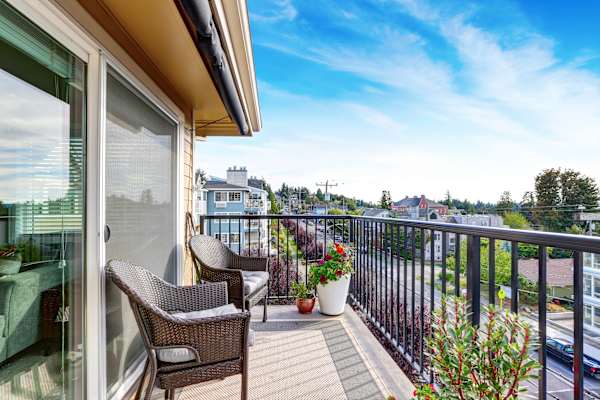 A balcony with a chair and a table.