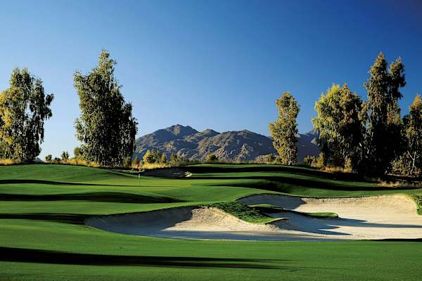 A golf course with a mountain in the background.