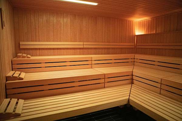 A row of wooden benches in a sauna.