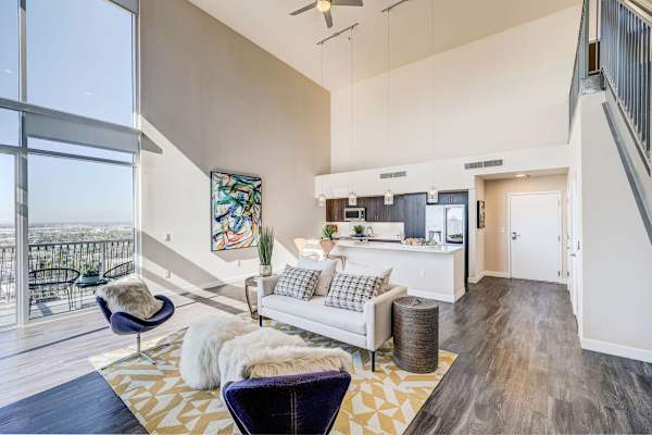 A living room with a white couch and a chair.