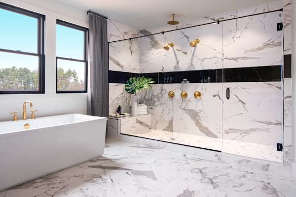 A bathroom with a marble floor and wall.