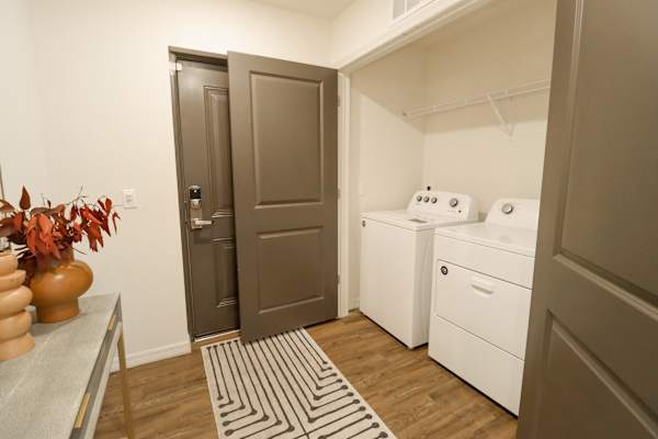 a small laundry room with a washer and dryer at The Crest at Naples, Naples, FL, 34113