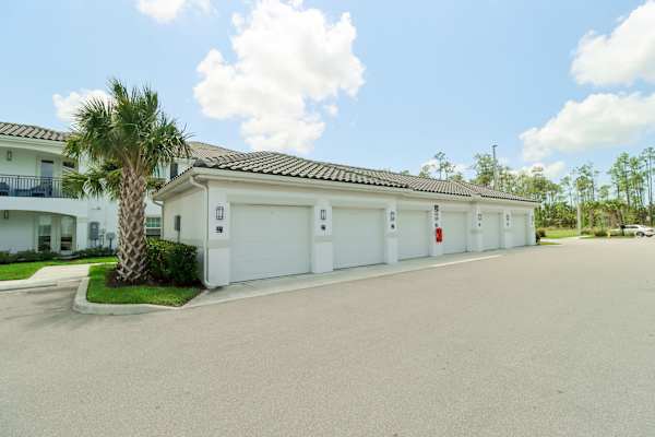 a house with a palm tree in front of it at The Crest at Naples, Naples, FL, 34113