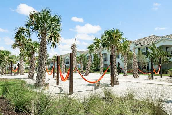 a hammock area in front of a row of houses at The Crest at Naples, Naples