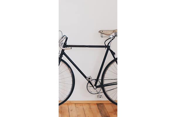 a bike parked in a room next to a wall